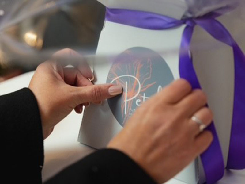 A bouquet being finished by hand at Petals Flowers
