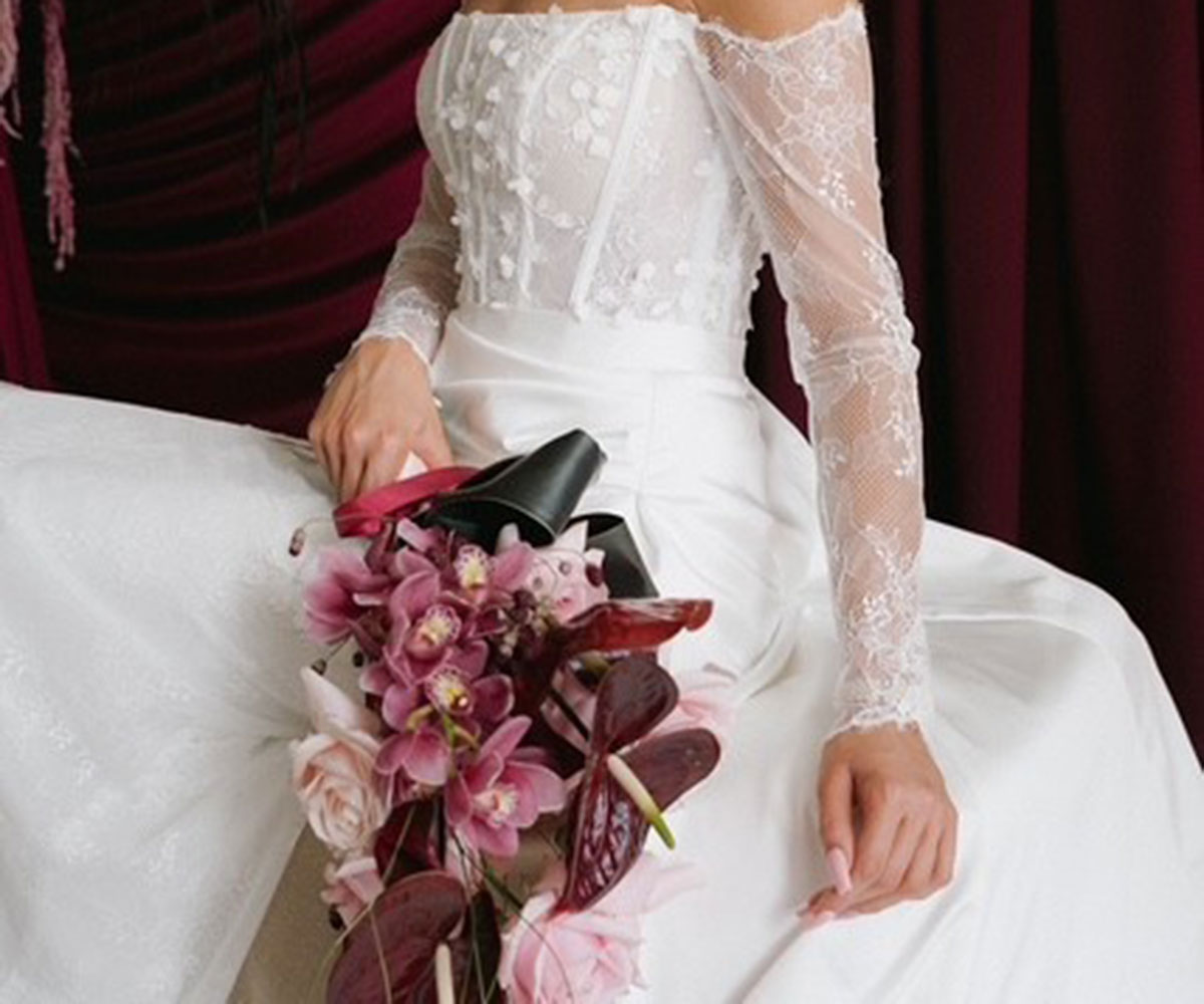 Bride holding wedding bouquet created by Petals Flowers